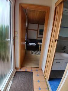 a door leading into a room with a bathroom at Ferienbungalow in Zirkow