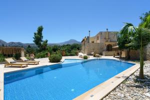 a swimming pool in the yard of a house at New Villa Myre 3, A Family-Friendly Retreat in Crete with Private Pool & 3 Apartments in Zourídhion