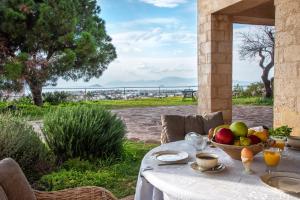 a table with a bowl of fruit on top of it at Artisan Villa Aegina in Aegina Town