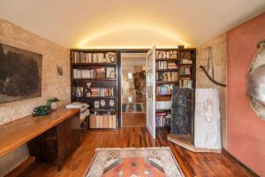a living room with bookshelves and a desk in a room at Artisan Villa Aegina in Aegina Town