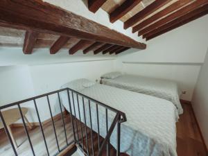 a room with two beds and a staircase at Il Loggiato del Corso in Città di Castello