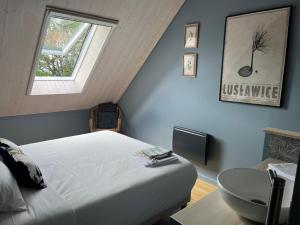 a bedroom with a bed and a table and a window at Les Caminols in La Dornac