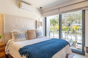 a bedroom with a bed and a large window at Vista Natura in Nuevo Vallarta +51 photos