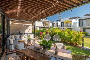 an outdoor patio with a table and chairs at Vista Natura in Nuevo Vallarta