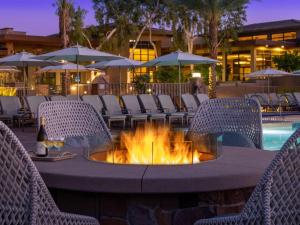a table with chairs and a fire pit at a resort at Westin Desert Willow Villas 1BR Apartment with Resort Access in Palm Desert