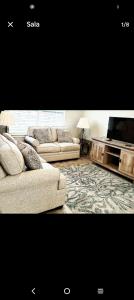 a living room with two couches and a tv at Beautiful house in quiet place shared bath in Ocala