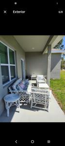 a porch with two chairs and a table and chairs at Beautiful house in quiet place shared bath in Ocala