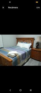 a bedroom with a bed and a laptop on a night stand at Beautiful house in quiet place shared bath in Ocala