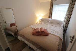 a bedroom with a bed with two towels on it at No 26 Town House in Killarney