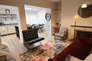 a living room with a couch and a dining room at No 26 Town House in Killarney