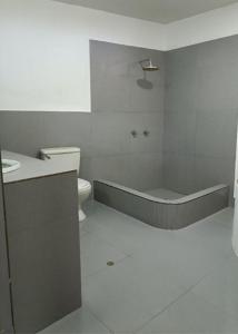 a bathroom with a tub and a toilet and a sink at Casa En Asia in San Antonio +2 photos