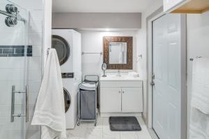 a white bathroom with a sink and a mirror at The Surf Retreat in Conejo Valley Trailer Park +30 photos