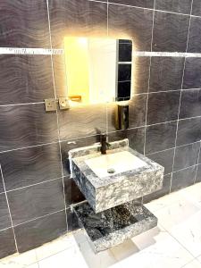a bathroom with a marble sink and a mirror at استديو Zara in Taif +4 photos
