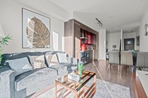 a living room with a couch and a table at 1-Bedroom & Den condo Bird's Eye View in DT in Toronto