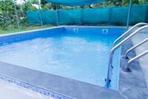 a swimming pool with two metal rails in it at Auro Ocean View Residency in Puducherry