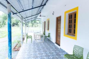 a patio with chairs and a table and a door at Auro Ocean View Residency in Puducherry