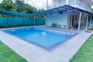 a swimming pool in the yard of a house at Auro Ocean View Residency in Puducherry