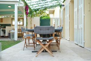 Una mesa y sillas de madera en un patio. en Villa La Mascotte, en Beaulieu-sur-Mer