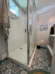 una ducha con puerta de cristal en un baño en Au Coeur du Fief Naton, en Le Château-dʼOléron 9 fotos más
