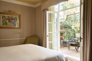a bedroom with a bed and an open door at Egerton House in London +136 photos