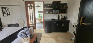a bedroom with a bed and a kitchen with a table at Diamond Stays in Aguada