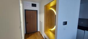 a hallway with a wooden door and a wooden floor at Extra Apartman Palata in Banja Luka