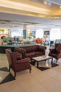 a lobby with couches and tables and chairs at Buyuk Berk Hotel in Ayvalık