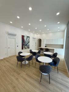 a room with tables and chairs and a kitchen at Elysium Relais in Naples