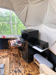 a room with a microwave and a table in a tent at Humble Hippie in Rogers