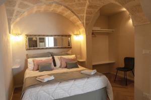 a bedroom with a large bed with an archway at La Suite del Faso in Fasano