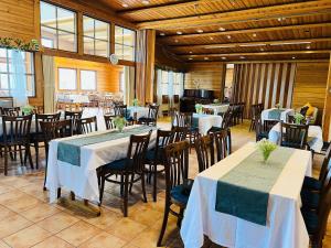 a dining room with tables and chairs in a building at Lakeside hotelli ravintola in Rantasalmi