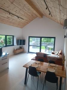 a kitchen and living room with a table and chairs at Franco'gîte in Francorchamps
