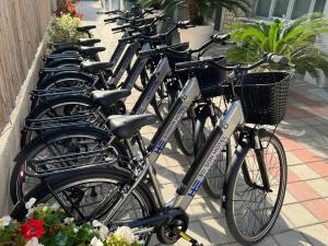 a row of bikes parked next to each other at Edison Hotel Seaview & SPA in Sottomarina