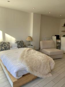 a bedroom with a white bed with a rug on it at Blue House in Stone Grove