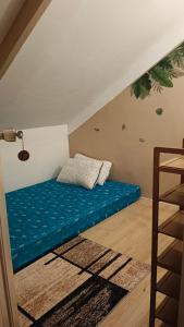 a room with a blue bed on the floor at Maligaya Maison in General Luna