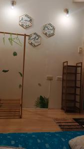 a living room with clocks on the wall at Maligaya Maison in General Luna