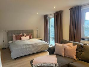 a bedroom with a bed and a couch at Herzstück Simonskall in Hürtgenwald
