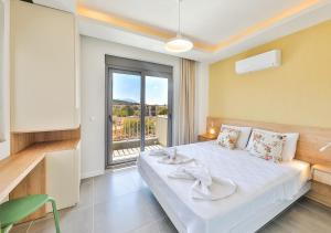 a bedroom with a bed and a large window at Villa Serenity in Kas