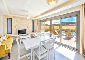 a living room with a table and chairs and a couch at Villa Serenity in Kas