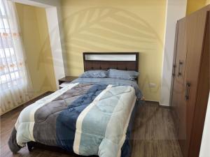 a bedroom with a large bed in a room at Las Palmas Apart in Tacna