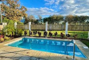 a swimming pool in a yard with a fence at Casa Verde in Uvita