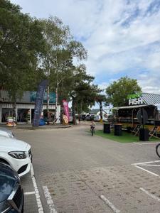 a person riding a bike down a street at Fun Like Hel Kite&Wind in Jastarnia +8 photos