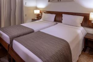 two beds sitting next to each other in a room at Serhs Villas Da Pipa Hotel in Pipa +27 photos