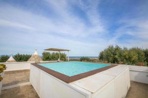 a swimming pool on the roof of a house at RebeaTrulliHome with Pool Fasano in Fasano