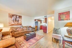 a living room with couches and a kitchen at The Painted Pony Sedona Condo Pool and Gym Access in Sedona
