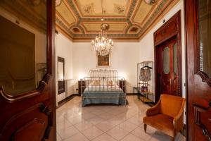 a bedroom with a bed in a room with a ceiling at Artista Apartment in Alcamo