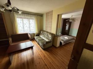 a living room with a couch and a table at Viršutinė 9 Pirtis in Klaipėda