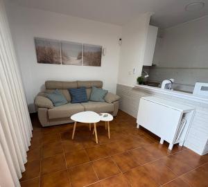 a living room with a couch and a table at Apartamento Oasis Alamillo in Puerto de Mazarrón
