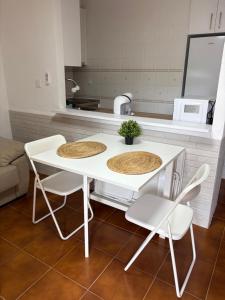 a white table and chairs in a kitchen at Apartamento Oasis Alamillo in Puerto de Mazarrón +21 photos