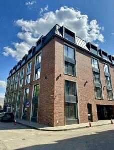 a large brick building with windows on a street at Jungle Apartment in Krakow